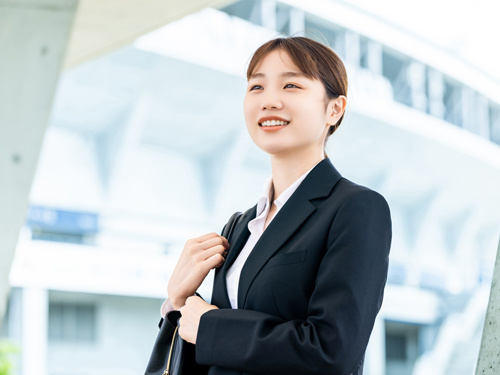 スーツの女性が前を向き未来へ向かっている写真