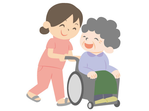 車いすを引く女性介護スタッフ