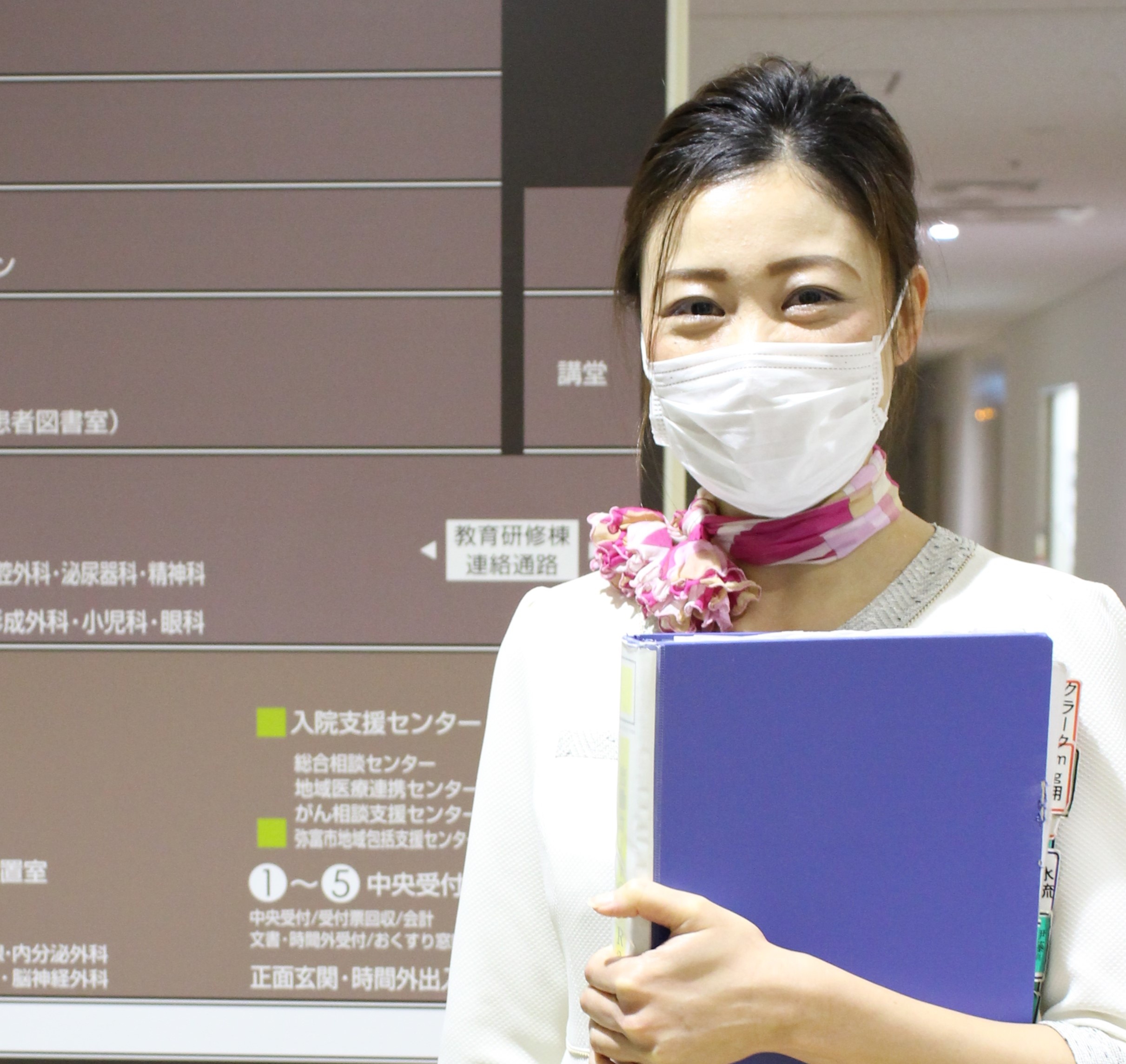 ファイルを抱えた女性事務員